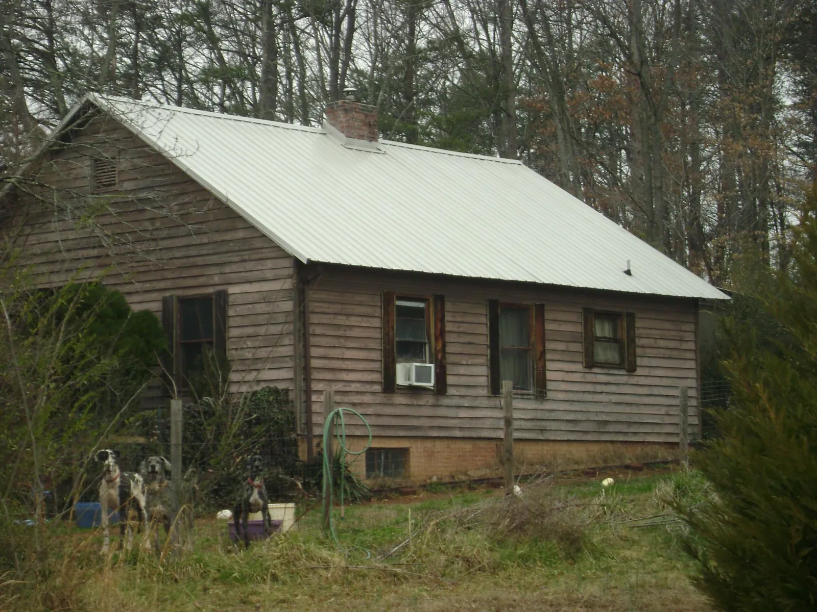 White metal roof on an old wood sided farmhouse in Fishersville